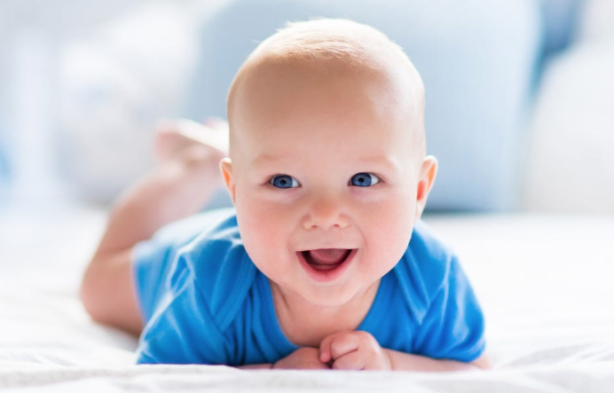 Smiling infant representing the postpartum period and hormonal changes after pregnancy